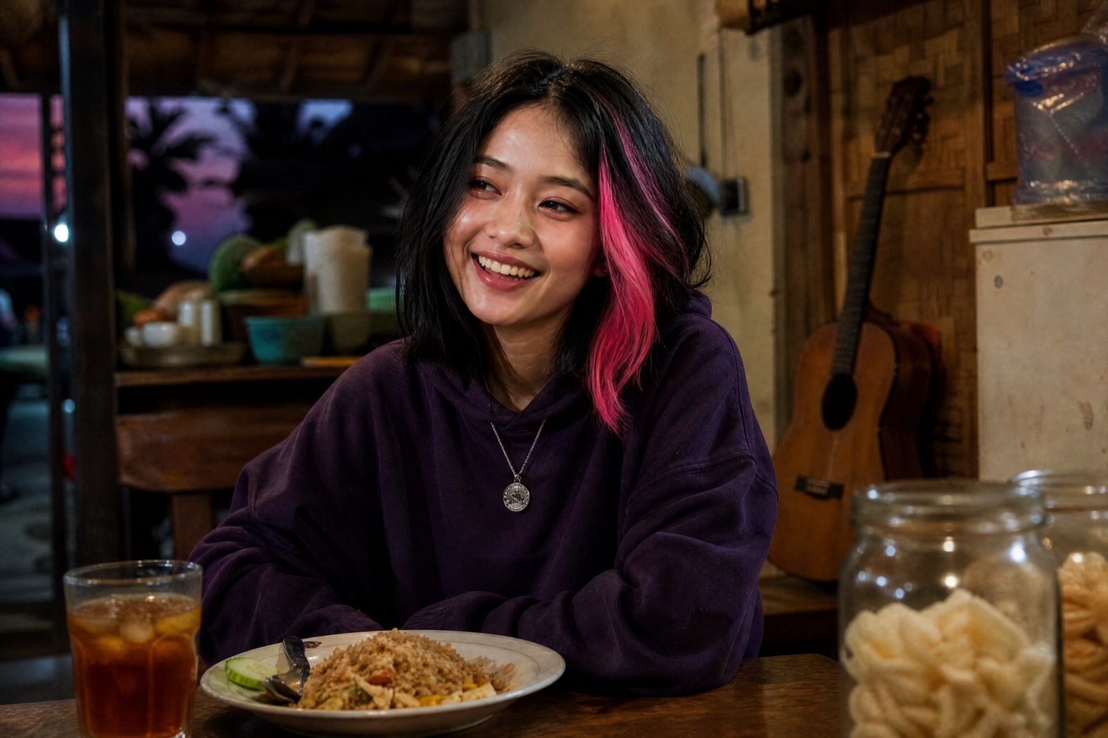 KIRANITA laughing at a table in her parents' warung, her father's guitar leaning on the wall behind her